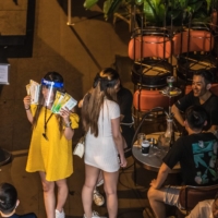 A customer holds packs of COVID-19 rapid antigen tests at a bar at the Lan Kwai Fong nightlife area in Hong Kong on Thursday.  | BLOOMBERG