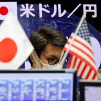 A dealing room of foreign exchange trading company Gaitame.com in Tokyo on Monday | REUTERS