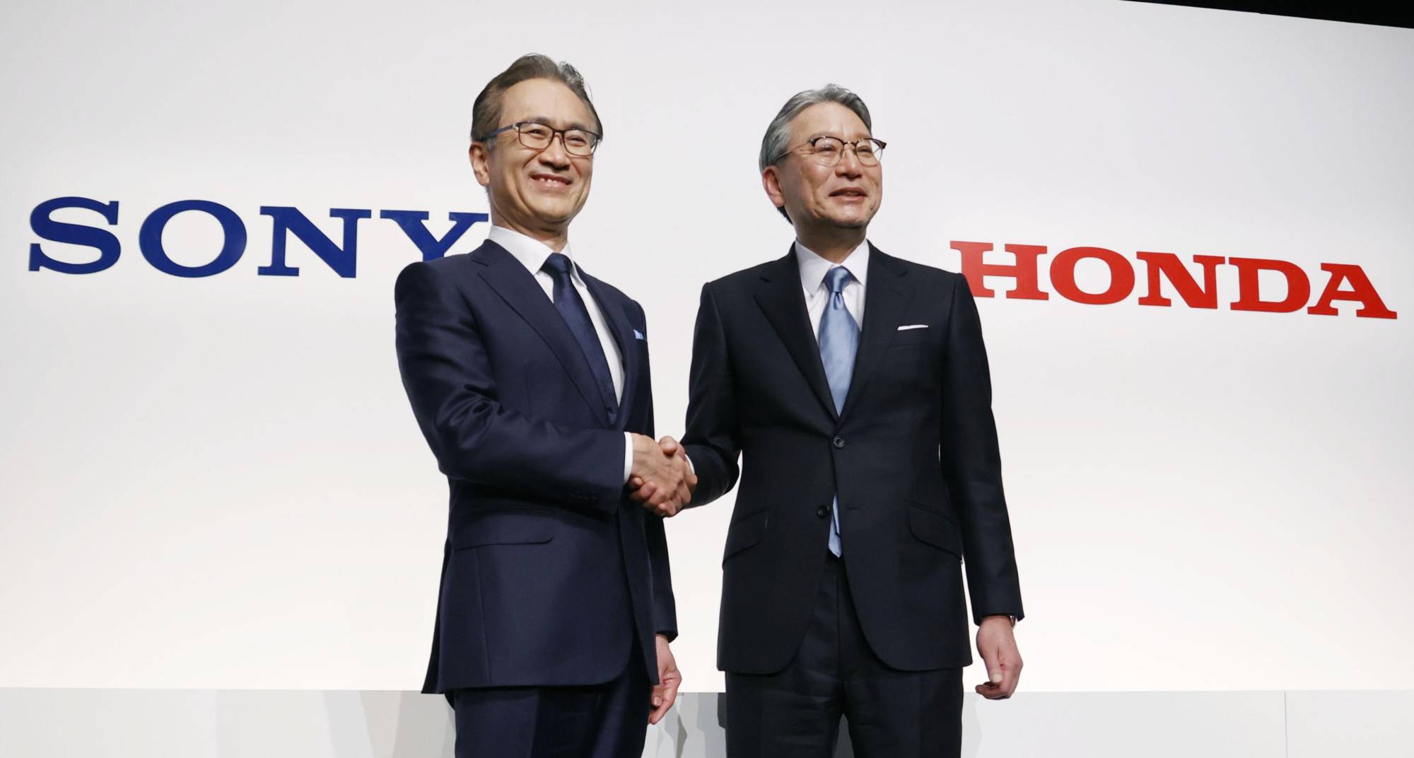 Kenichiro Yoshida (left), Sony Group's president, chairman and CEO, and Honda Motor President Toshihiro Mibe at a news conference in Tokyo in March | KYODO