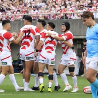 Brave Blossoms players celebrate Koga Nezuka\'s opening try against Uruguay at Prince Chichibu Memorial Rugby Ground on Saturday. | KYODO