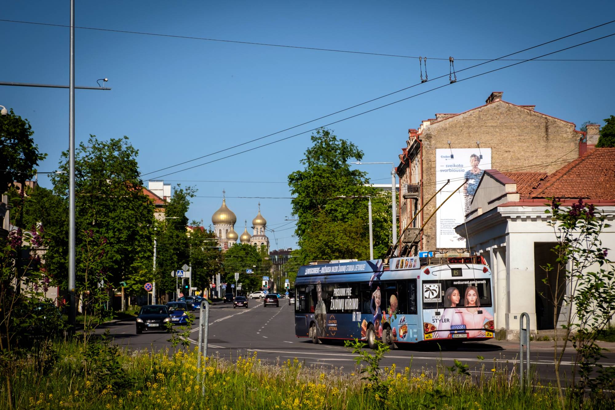 A trolly bearing an ad for game-maker Nordcurrent rolls through Vilnius, Lithuania, on May 23. The company’s Ukrainian employees say their new home city is easy to navigate. | Gordon Welters / The New York Times