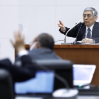 Bank of Japan Gov. Haruhiko Kuroda speaks at a news conference in Tokyo on Friday. | POOL / VIA KYODO