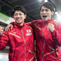 Gymnasts Shota Tanigawa (left) and Kakeru Tanigawa celebrate after making Japan\'s team for the world championships on Sunday. | KYODO