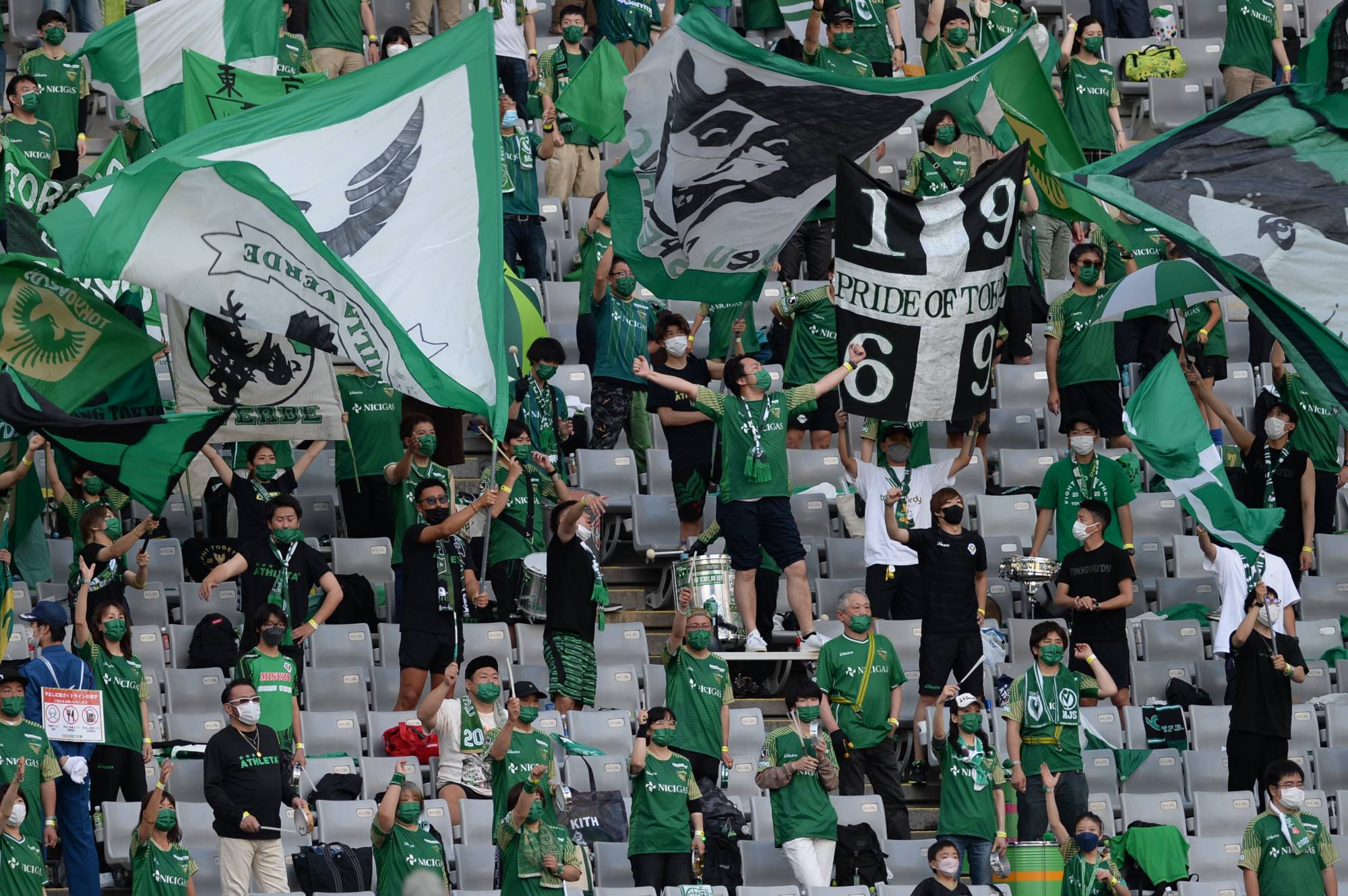 Tokyo Verdy fans at the team's home game at Ajinomoto Stadium in Chofu, western Tokyo, on June 12. Fans in cheering sections were required to chant facing the pitch to reduce the risk of infections. | DAN ORLOWITZ