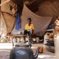 An 11-year-old boy sits inside a makeshift shelter at a camp for internally displaced people in Dollow, Somalia, on May 25. | REUTERS