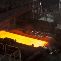 A hot steel slab moves along a conveyor at a Nippon Steel plant in Kashima, Ibaraki Prefecture. | BLOOMBERG