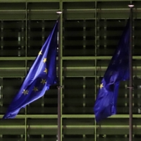 European flags flutter outside the headquarters of the European Commission in Brussels on Feb. 24.  | BLOOMBERG