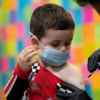 A 3-year-old receives the Moderna COVID-19 vaccine at Skippack Pharmacy in Schwenksville, Pennsylvania, on Monday. | REUTERS