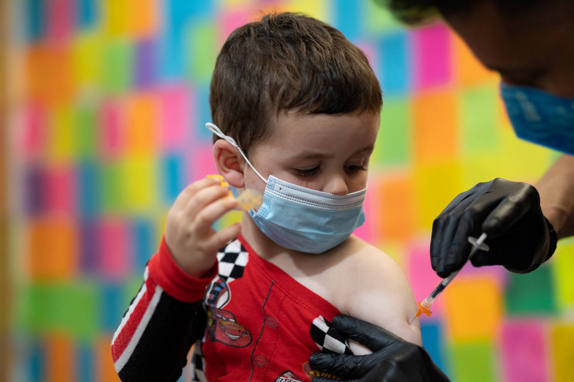 A 3-year-old receives the Moderna COVID-19 vaccine at Skippack Pharmacy in Schwenksville, Pennsylvania, on Monday. | REUTERS