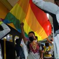 Supporters of LGBT rights walk under a rainbow flag at the Rainbow Market since the annual pride parade was cancelled for the last two years due to the outbreak of COVID-19 in Hong Kong, in November 2021. | REUTERS