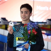 Yu Hanaguruma poses with his medal after the men\'s 200-meter breaststroke final at the swimming world championships in Budapest on Thursday. | REUTERS