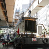 A part of the Metropolitan Expressway near Nihonbashi bridge in Tokyo is removed on Friday. | KYODO