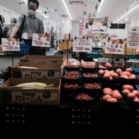 A customer inside a greengrocer in Ikeda, Osaka Prefecture, last week. Daiwa Securities says that households are becoming “more budget-minded,” based on its so-called luxury index. | BLOOMBERG
