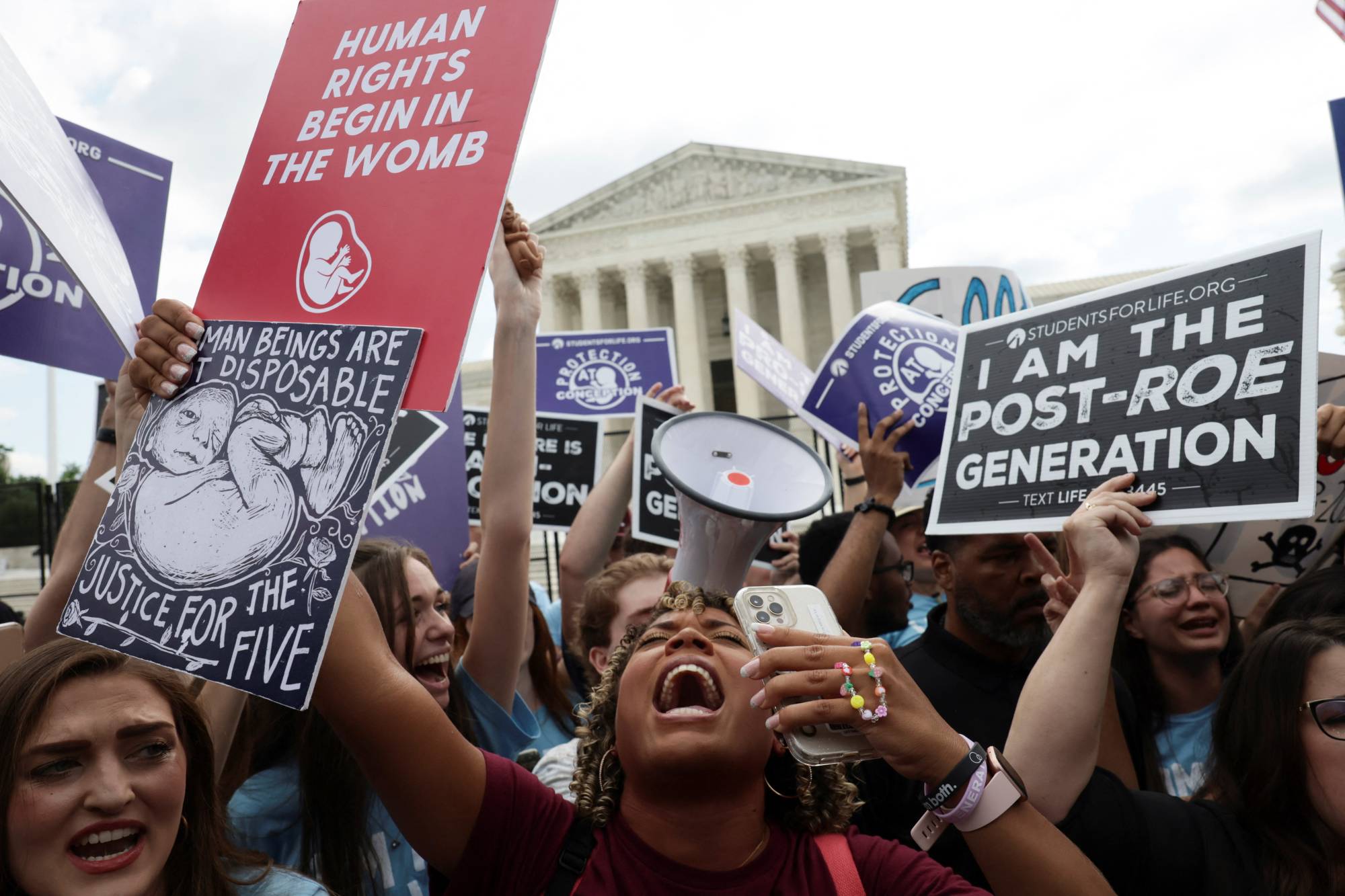 Anti-abortion demonstrators celebrate outside the United States Supreme Court in Washington on Friday. | Reuters 