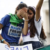 Abortion rights demonstrators react outside the U.S. Supreme Court in Washington on Friday.  | BLOOMBERG 