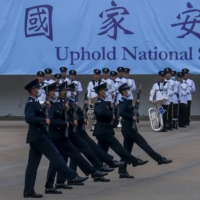 Police officers perform a drill during National Security Education Day at the Hong Kong Police College in 2021.  | BLOOMBERG
