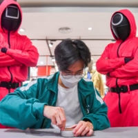 A man participates in a Netflix series \'Squid Game\' mission at a department store in Bangkok in November 2021. | REUTERS