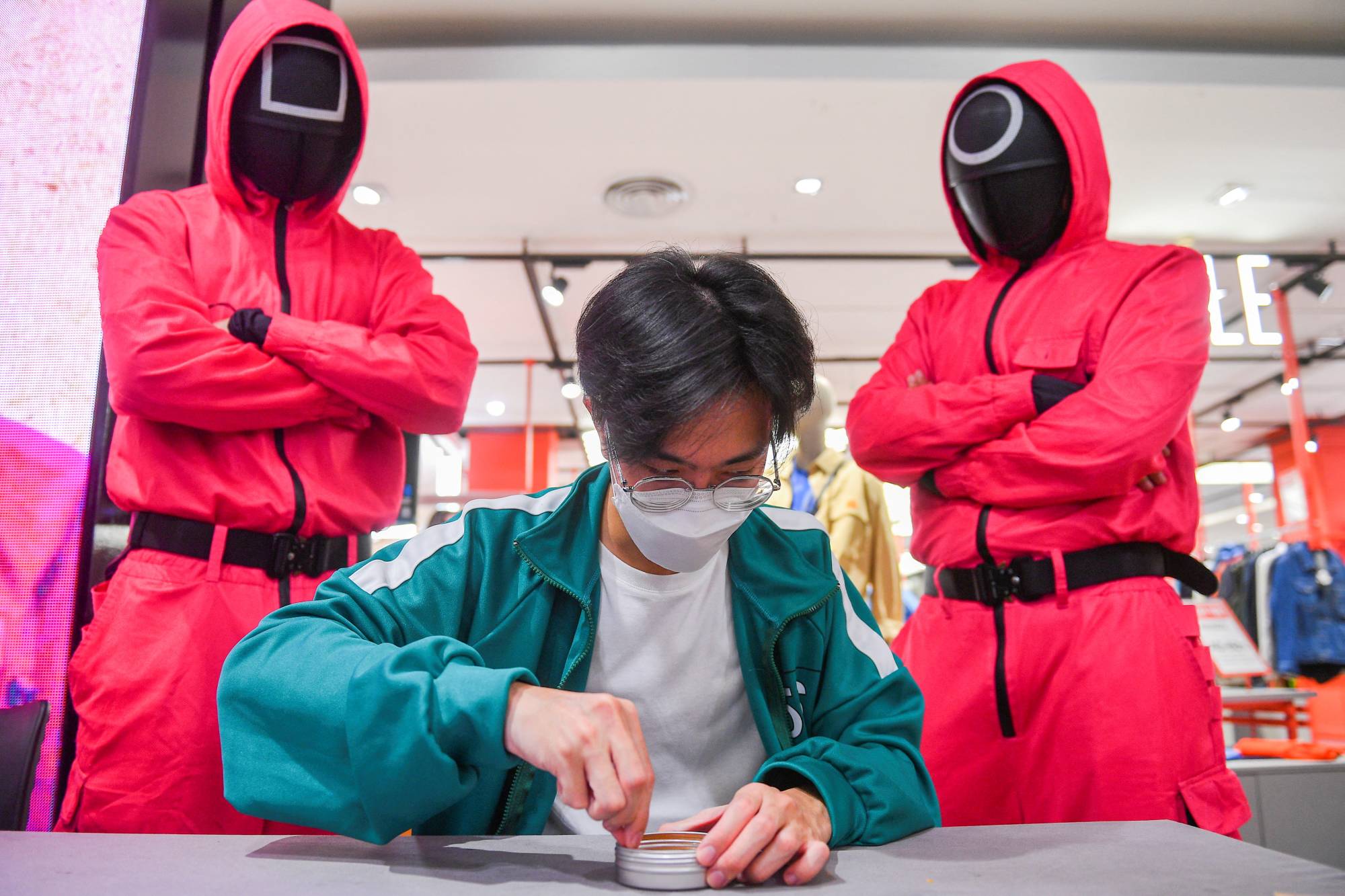 A man participates in a Netflix series 'Squid Game' mission at a department store in Bangkok in November 2021. | REUTERS