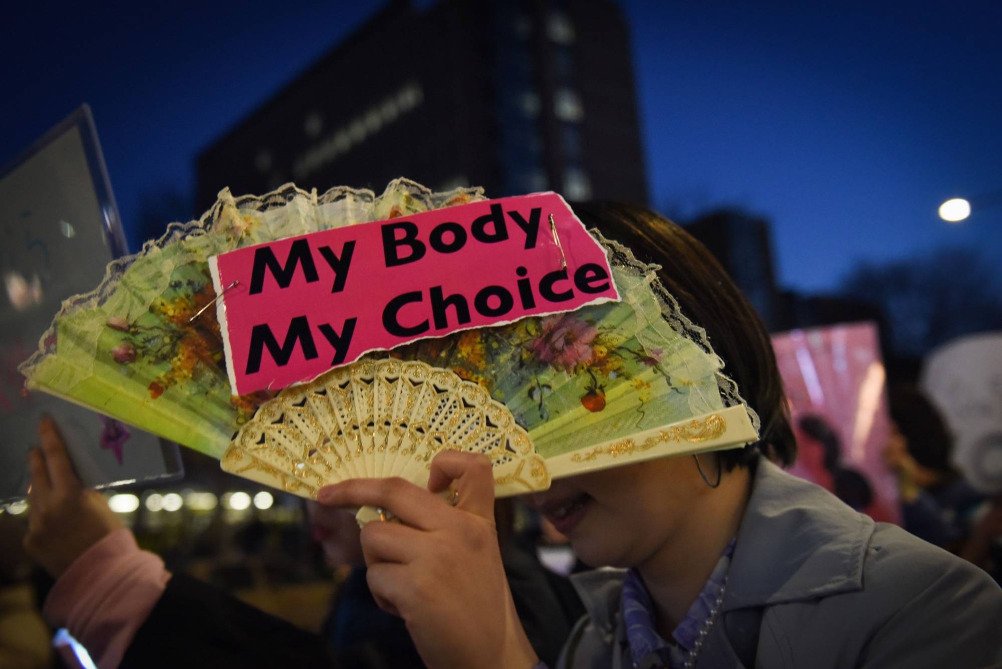 A participant in a Women's Day march in Tokyo in 2019 | BLOOMBERG