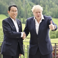 Prime Minister Fumio Kishida (left) and his British counterpart Boris Johnson in Schloss Elmau, southern Germany, on Tuesday | POOL / VIA KYODO