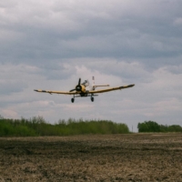 John Lepp seeds wet spots in a field with canola by airplane, while his daughter, Cassandra Lepp, plants the crops with a tractor near Rivers, Manitoba, on May 27. | STEFANIE LEPP / VIA REUTERS    