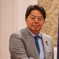 Philippine Vice President-elect Sara Duterte-Carpio shakes hands with Foreign Minister Hayashi Yoshimasa, during a courtesy visit at a hotel in Manila on Wednesday. | REUTERS