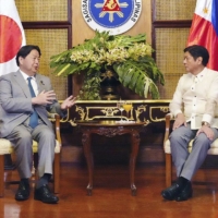 Foreign Minister Yoshimasa Hayashi (left) and new Philippine President Ferdinand Marcos Jr. hold talks in Manila on Thursday. | FOREIGN MINISTRY / VIA KYODO