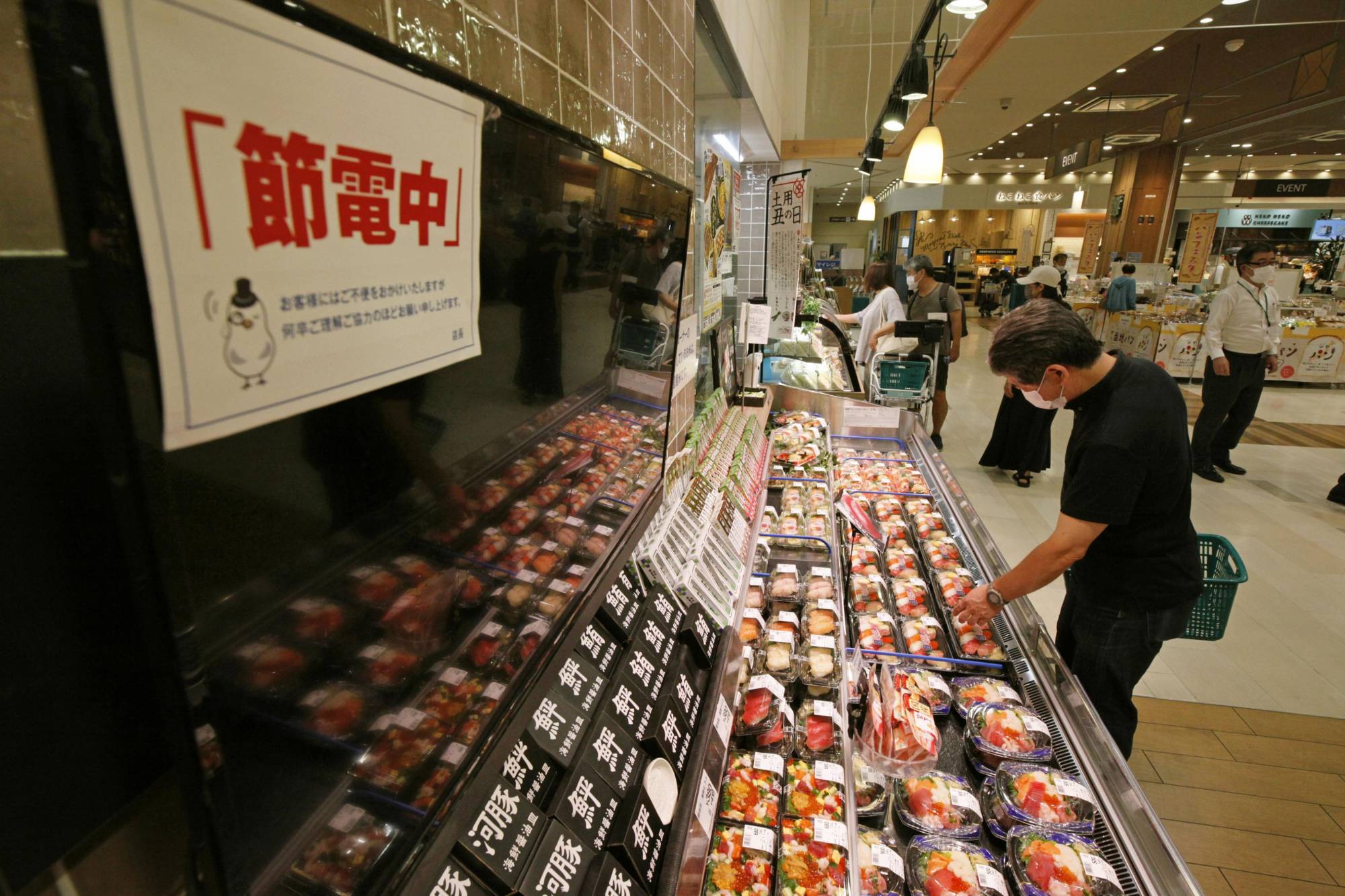 Promotional displays are turned off on Friday at a supermarket in Tokyo's Ota Ward as part of efforts to save electricity. | KYODO