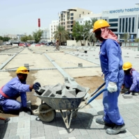 Foreign workers at a construction site in Muscat on June 21 | AFP-JIJI