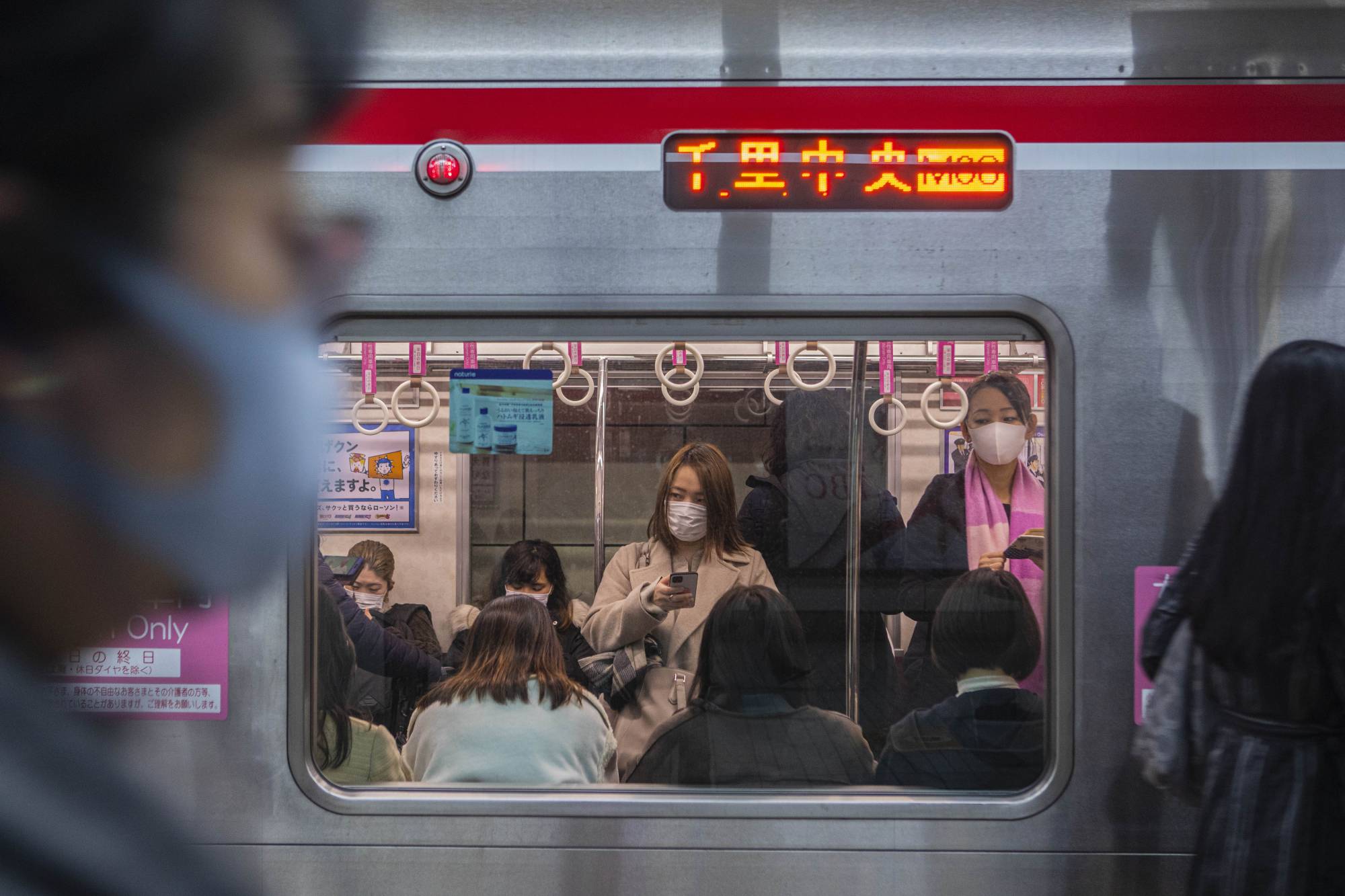 Women ride a subway car in Osaka. Many factors have undoubtedly contributed to Japan’s coronavirus outcomes. But social conformity — and a fear of public shaming that is instilled from the youngest ages — has been a key ingredient in Japan’s relative success in COVID prevention, experts say. | Hiroko Masuike / The New York Times