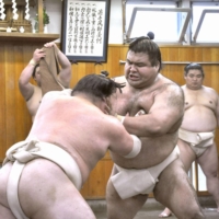 Former ozeki Takayasu (right) tested positive for COVID-19 on Tuesday. | KYODO
