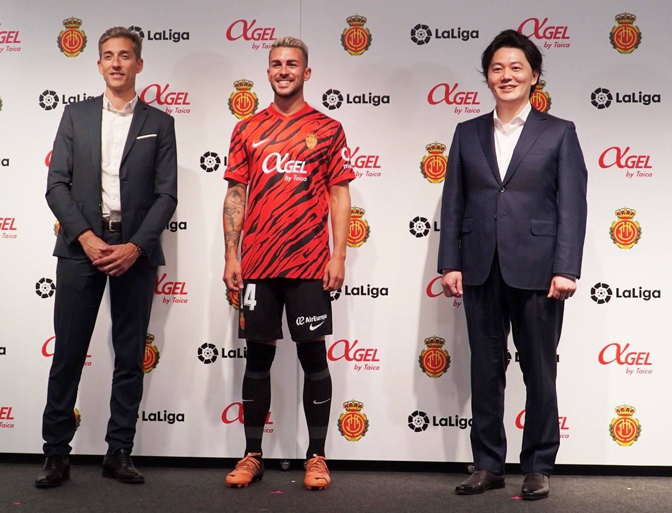 RCD Mallorca captain Dani Rodriguez (center) poses with the team's 2022-23 uniform, along with the club's CEO of business Alfonso Diaz (left) and Taica CEO Taito Suzuki, at a media event in Tokyo's Minato Ward on Friday. | RCD MALLORCA
