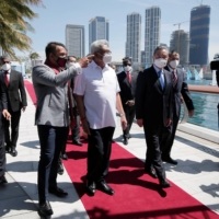 Chinese Foreign Minister Wang Yi (right) arrives with Sri Lankan President Gotabaya Rajapaksa (center) and its sports minister, Namal Rajapaksa, during his visit to Colombo in January. | REUTERS