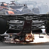 Zhou Guanyu\'s car skids upside down across the track after a collision during the British Grand Prix in Silverstone, England, on Sunday. | AFP-JIJI