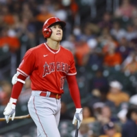 The Angels\' Shohei Ohtani returns to the dugout after striking out against the Astros during the eighth inning in Houston on Sunday. | KYODO