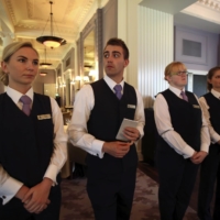 Waitstaff gather for a meeting before starting service at Scotland\'s Gleneagles Hotel in 2014. | REUTERS
