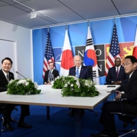 U.S. President Joe Biden sits with Yoon and Prime Minister Fumio Kishida during a trilateral meeting on the sidelines of the NATO summit in Madrid on June 29. | AFP-JIJI