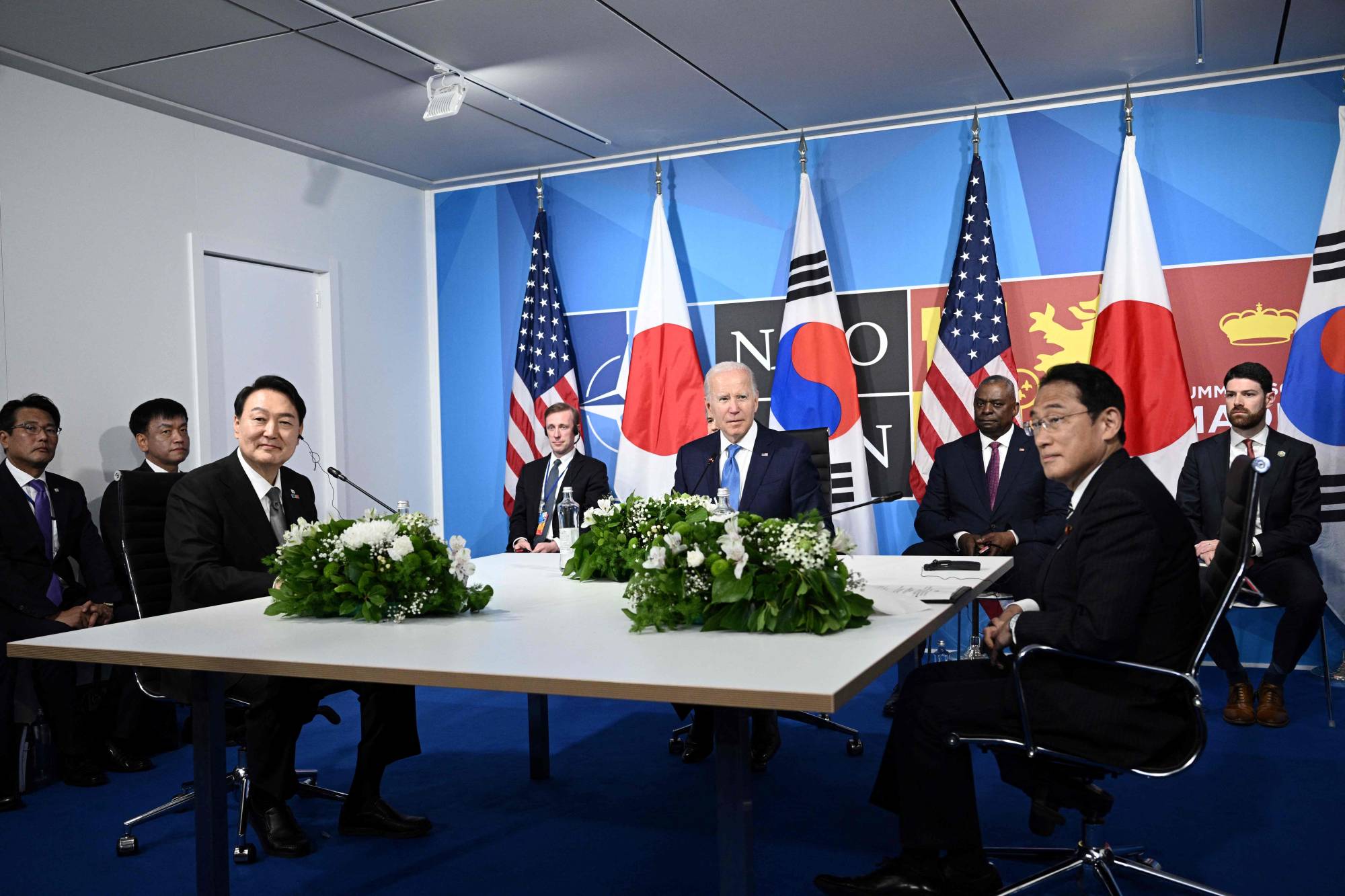 U.S. President Joe Biden sits with Yoon and Prime Minister Fumio Kishida during a trilateral meeting on the sidelines of the NATO summit in Madrid on June 29. | AFP-JIJI