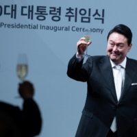 South Korean President Yoon Suk-yeol proposes a toast to foreign guests during an inaugural dinner at a hotel in Seoul on May 10. | POOL / VIA REUTERS