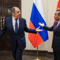 Russian Foreign Minister Sergey Lavrov (left) meets with his Chinese counterpart Wang Yi in Denpasar, Indonesia, on Thursday. | RUSSIAN FOREIGN MINISTRY / VIA AFP-JIJI