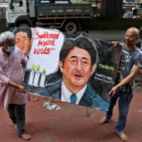 Artists display a memorial painting of Abe, outside an art school in Mumbai on Friday. | REUTERS