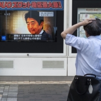 A television broadcast shown on a street in Tokyo on Friday reports about the attack on former Prime Minister Shinzo Abe. 
 | AFP-JIJI