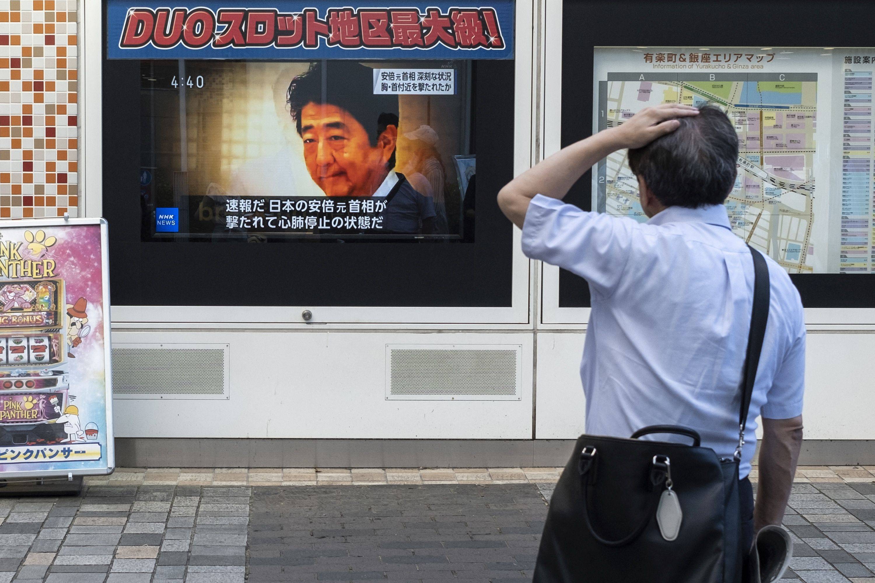 A television broadcast shown on a street in Tokyo on Friday reports about the attack on former Prime Minister Shinzo Abe. 
 | AFP-JIJI
