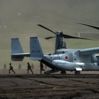Ground Self-Defense Force members disembark from a V-22 Osprey aircraft during an annual live-fire exercise at the East Fuji Maneuver Area in Gotemba, Shizuoka Prefecture, on May 28.  | POOL / VIA REUTERS