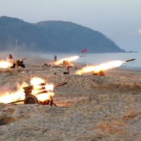 Multiple launch rocket batteries are fired in this undated photo released in December 2016.  | KCNA / VIA REUTERS