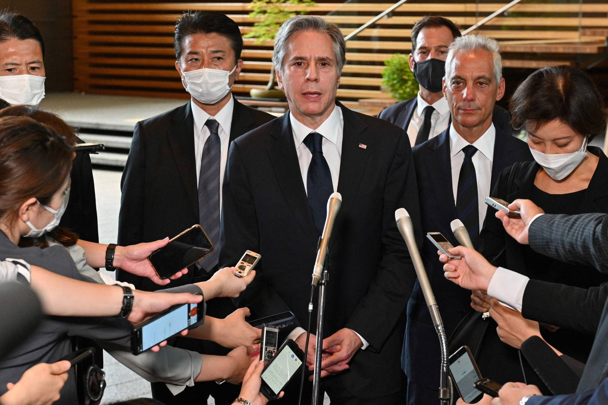 U.S. Secretary of State Antony Blinken (center) speaks to the media next to U.S. Ambassador to Japan Rahm Emanuel (center right) after meeting with Prime Minster Fumio Kishida at the Prime Minister's Office in Tokyo on Monday. | AFP-JIJI