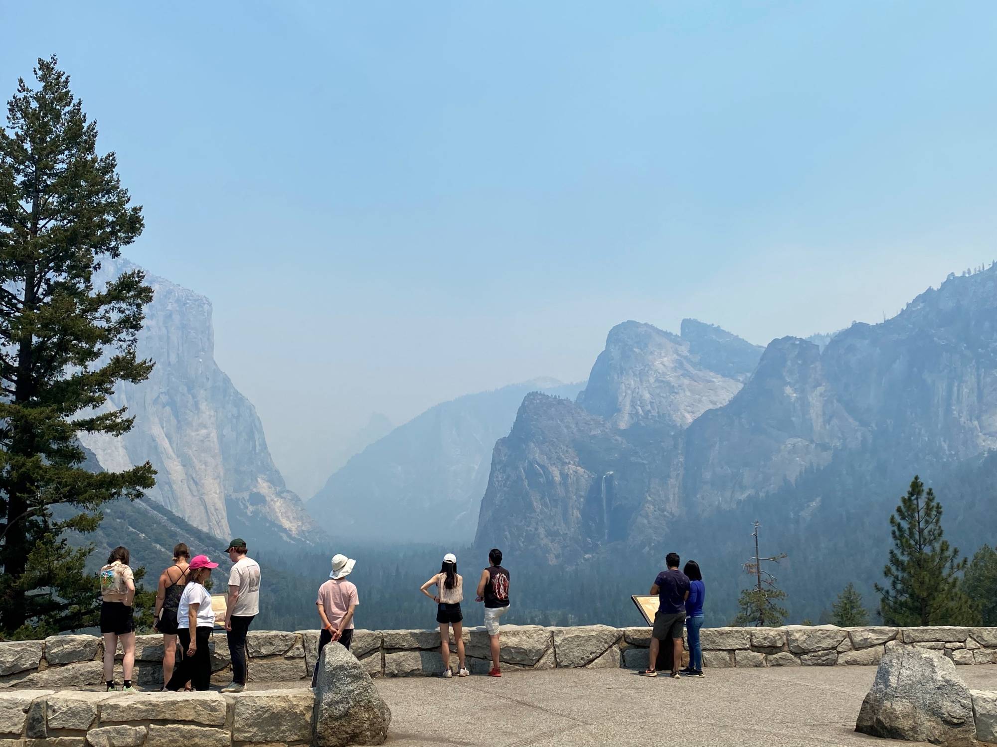 Visitors view Yosemite National Park obscured by thick smoke in the area from the wildfire burning to the south in the Mariposa Grove of Giant Sequoias in California on Saturday. | U.S. National Park Service / via REUTERS 