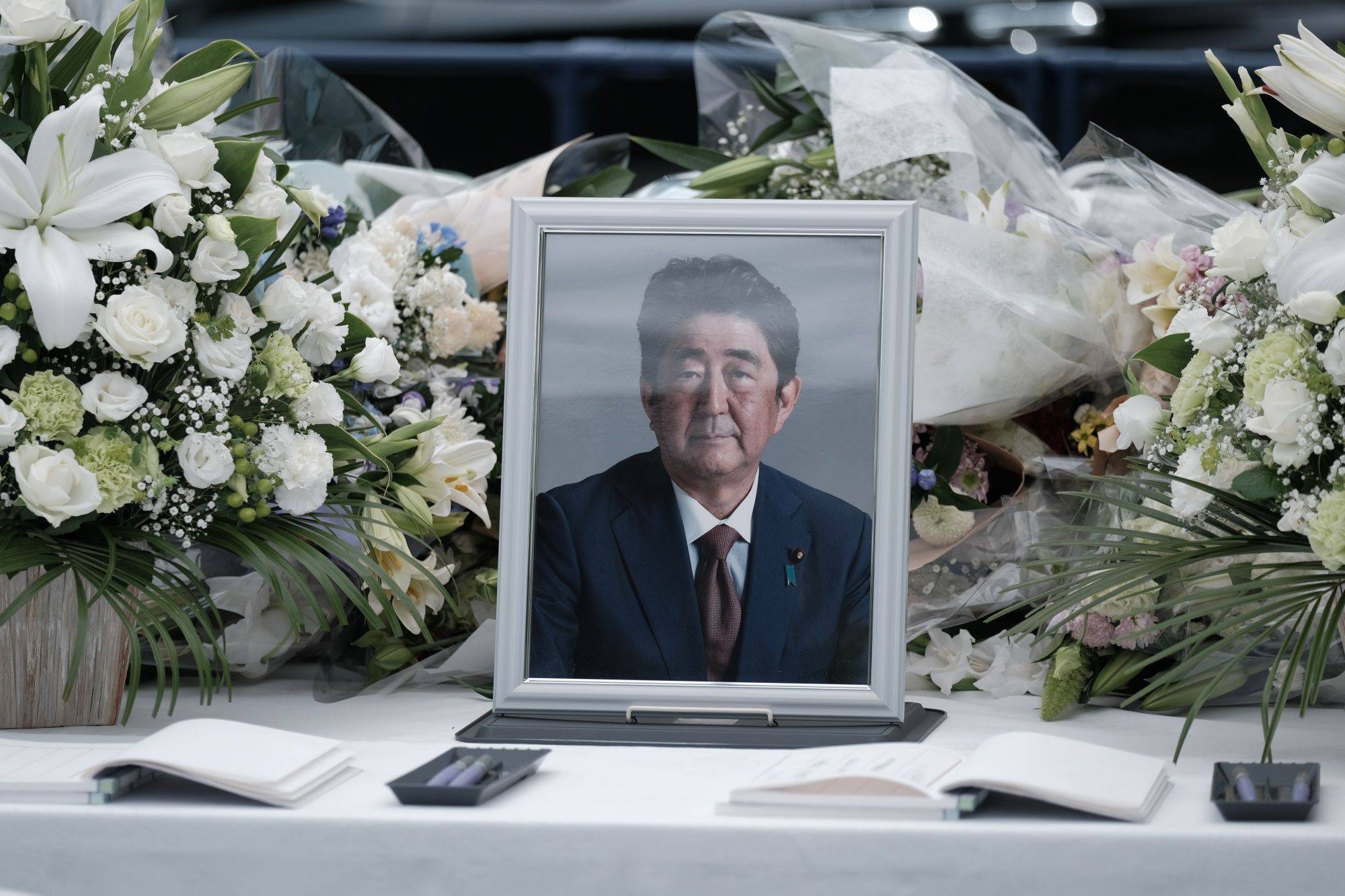 A photograph of former Prime Minister Shinzo Abe at a makeshift memorial at the Liberal Democratic Party headquarters in Tokyo on Monday | BLOOMBERG