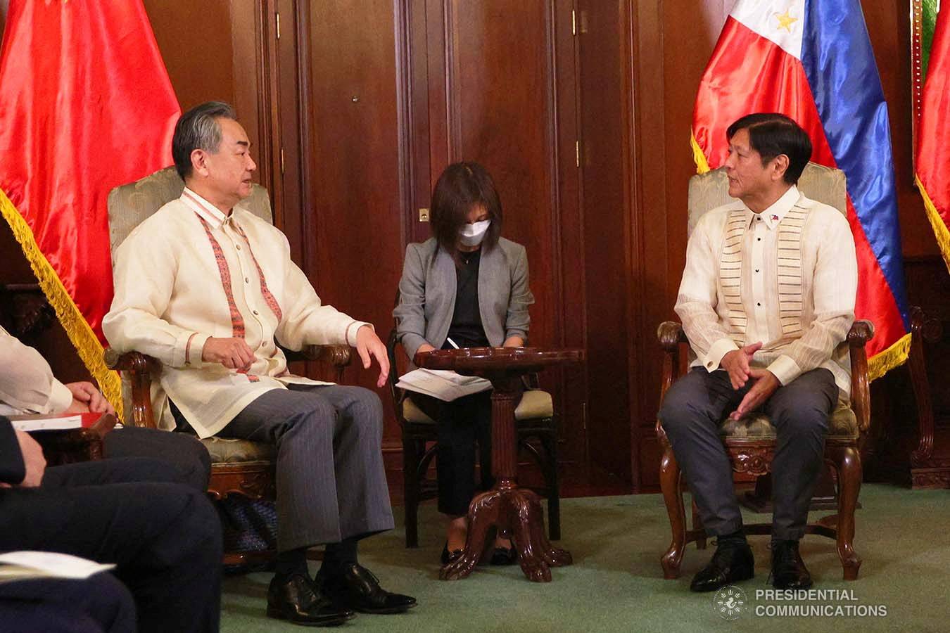 Chinese Foreign Minister Wang Yi speaks with Philippine President Ferdinand Marcos Jr. at Malacanang Palace in Manila on July 6. | Presidential Photographers Division / via REUTERS