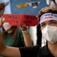 Filipino activists stage a protest outside the Chinese consular office in Makati City, Philippines, on the sixth anniversary of an international tribunal ruling that invalidated China\'s historical claims in the South China Sea. | REUTERS 